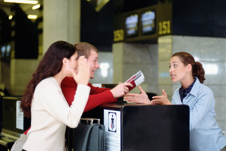 passengers-speaking-check-agent-airport.jpg