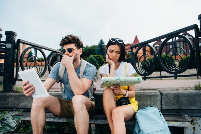 tourists-bored-looking-map-outdoors.jpg